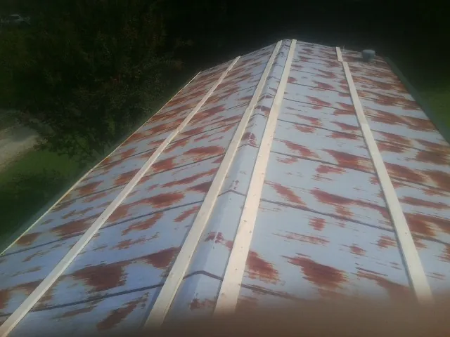 Rusted metal roof panels with new wood purlins before replacement — Storm Damage Roof Repair in Lake Hill by Roofing Brothers