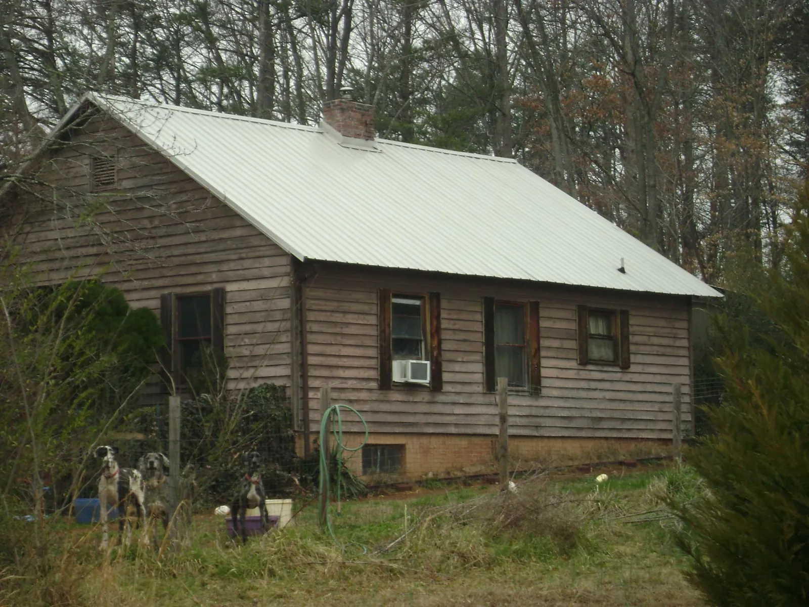 White metal roof on an old wood sided farmhouse, from a Asphalt Shingle Roof Repair job in Lake Hill